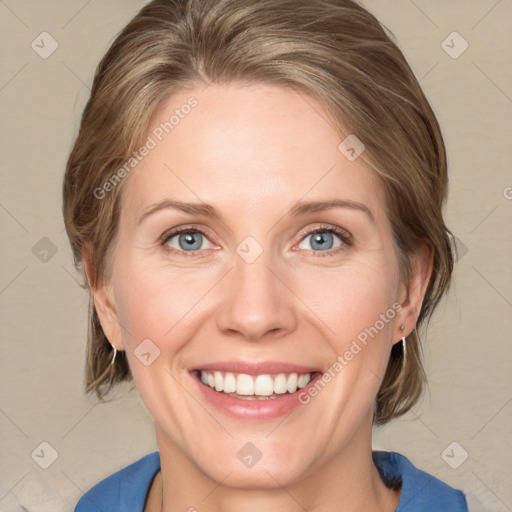 Joyful white adult female with medium  brown hair and blue eyes