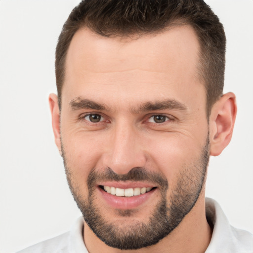 Joyful white young-adult male with short  brown hair and brown eyes