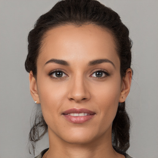 Joyful white young-adult female with medium  brown hair and brown eyes