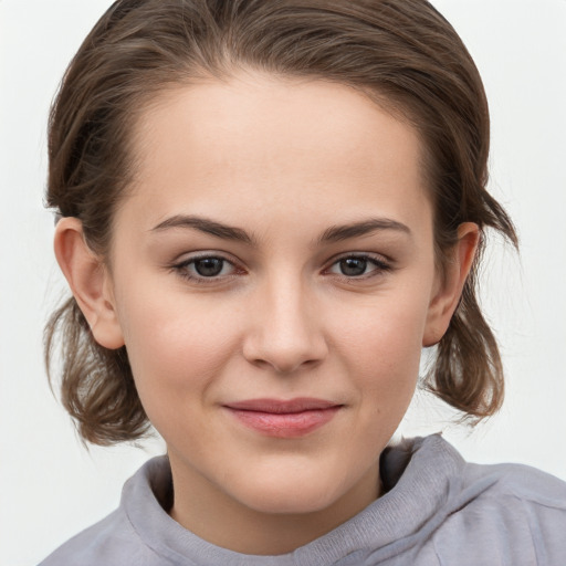 Joyful white child female with medium  brown hair and grey eyes