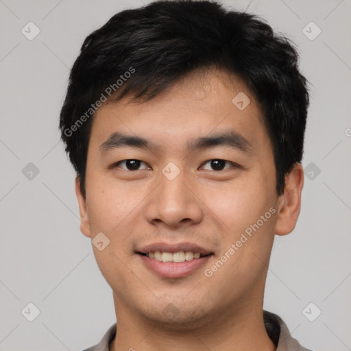 Joyful asian young-adult male with short  black hair and brown eyes