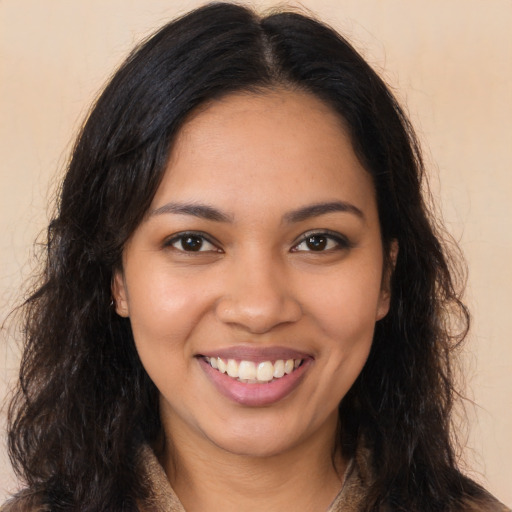 Joyful latino young-adult female with long  brown hair and brown eyes