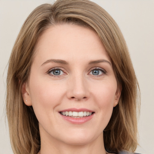 Joyful white young-adult female with medium  brown hair and green eyes