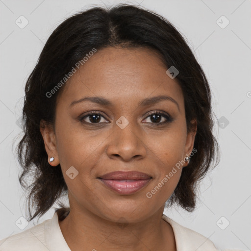 Joyful black adult female with medium  brown hair and brown eyes