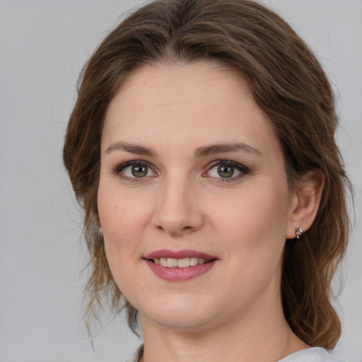 Joyful white young-adult female with medium  brown hair and grey eyes