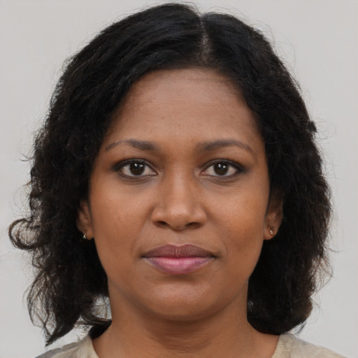 Joyful black young-adult female with medium  brown hair and brown eyes