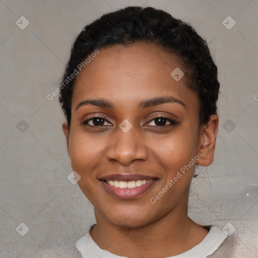 Joyful black young-adult female with short  black hair and brown eyes