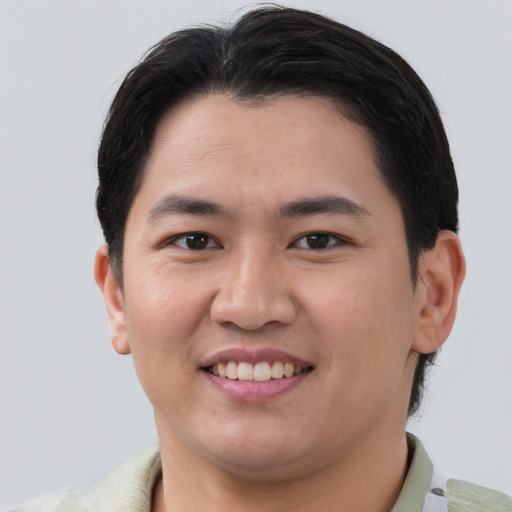 Joyful asian young-adult male with short  brown hair and brown eyes