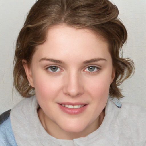 Joyful white young-adult female with medium  brown hair and blue eyes