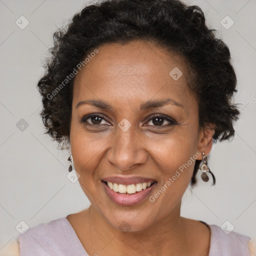 Joyful black adult female with short  brown hair and brown eyes