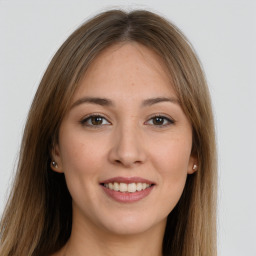 Joyful white young-adult female with long  brown hair and brown eyes