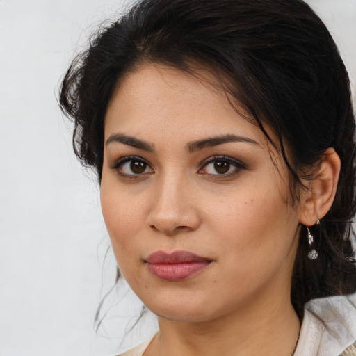 Joyful latino young-adult female with medium  brown hair and brown eyes