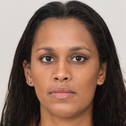 Neutral black young-adult female with long  brown hair and brown eyes