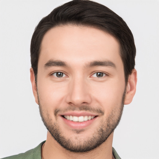 Joyful white young-adult male with short  brown hair and brown eyes