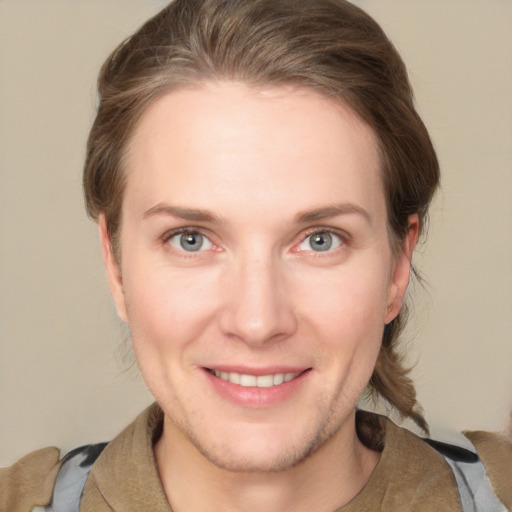 Joyful white adult female with medium  brown hair and grey eyes