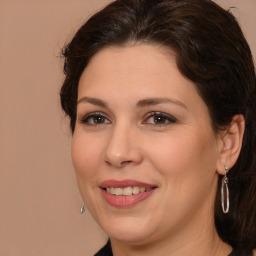 Joyful white adult female with medium  brown hair and brown eyes