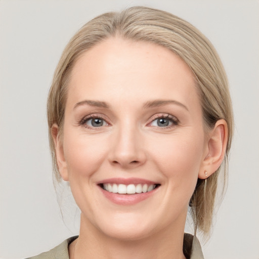 Joyful white young-adult female with medium  brown hair and blue eyes