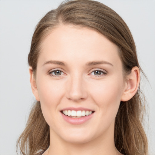 Joyful white young-adult female with long  brown hair and grey eyes