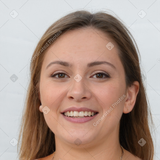 Joyful white young-adult female with long  brown hair and brown eyes