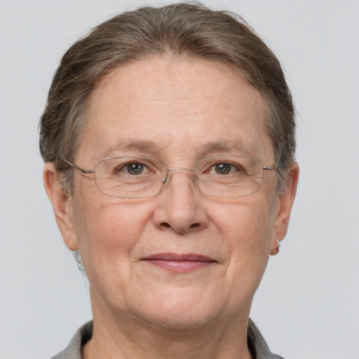 Joyful white middle-aged female with short  brown hair and grey eyes