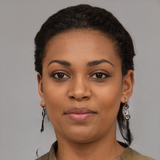 Joyful black young-adult female with short  black hair and brown eyes