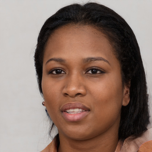 Joyful black young-adult female with medium  black hair and brown eyes