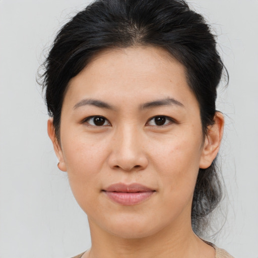Joyful asian young-adult female with medium  brown hair and brown eyes