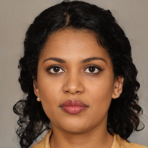 Joyful black young-adult female with medium  black hair and brown eyes