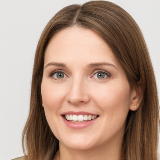 Joyful white young-adult female with long  brown hair and grey eyes