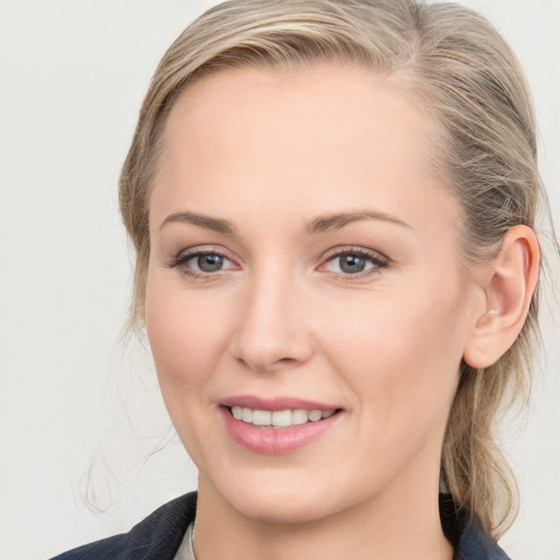 Joyful white young-adult female with medium  brown hair and blue eyes