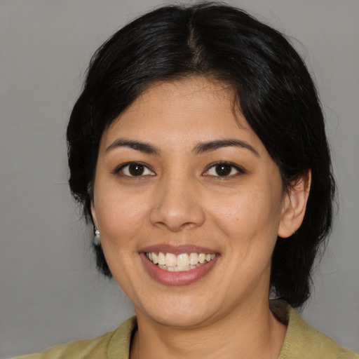 Joyful latino young-adult female with medium  black hair and brown eyes