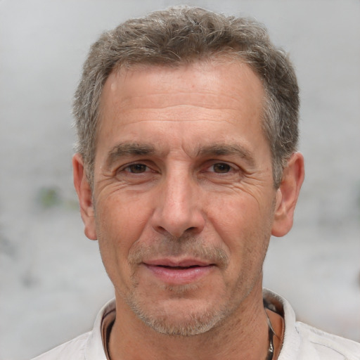 Joyful white middle-aged male with short  brown hair and brown eyes