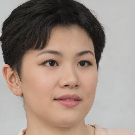 Joyful asian young-adult female with short  brown hair and brown eyes