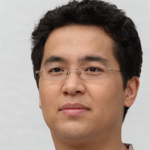 Joyful asian adult male with short  brown hair and brown eyes