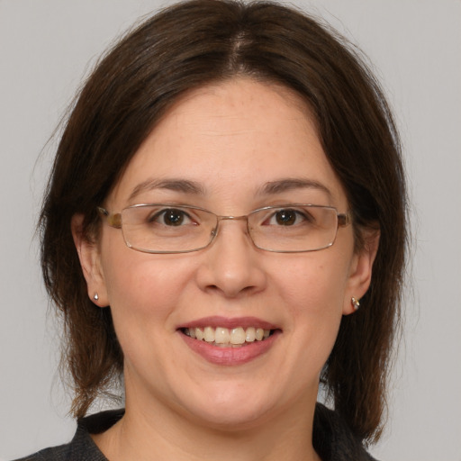 Joyful white adult female with medium  brown hair and brown eyes