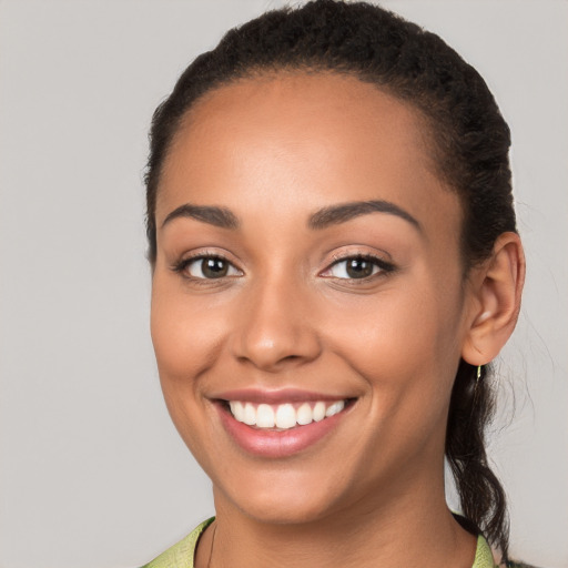 Joyful white young-adult female with long  brown hair and brown eyes