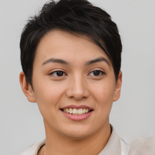 Joyful asian young-adult female with short  brown hair and brown eyes