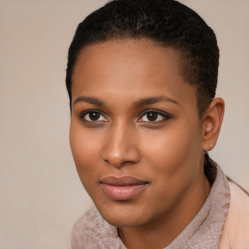 Joyful black young-adult female with short  black hair and brown eyes