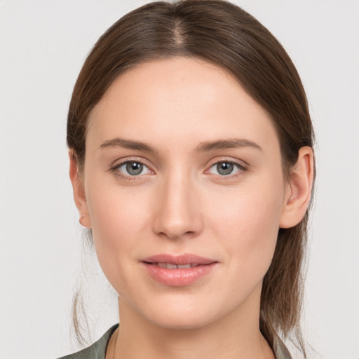 Joyful white young-adult female with medium  brown hair and grey eyes