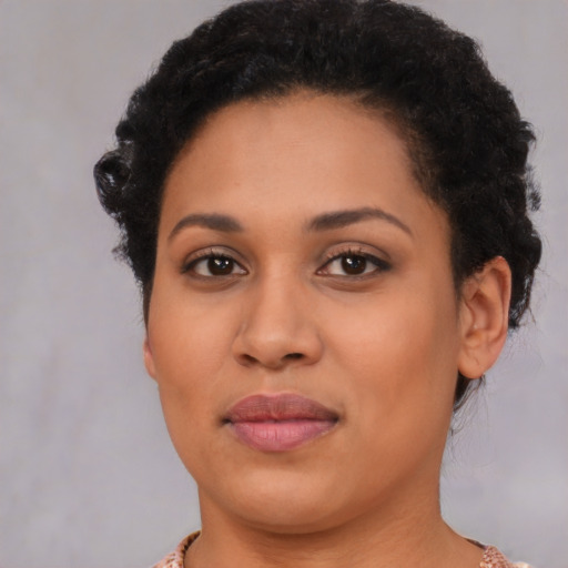 Joyful black young-adult female with short  brown hair and brown eyes