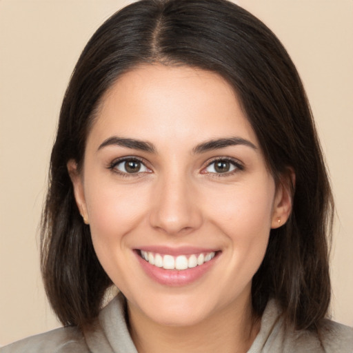 Joyful white young-adult female with medium  brown hair and brown eyes