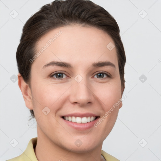 Joyful white young-adult female with short  brown hair and grey eyes