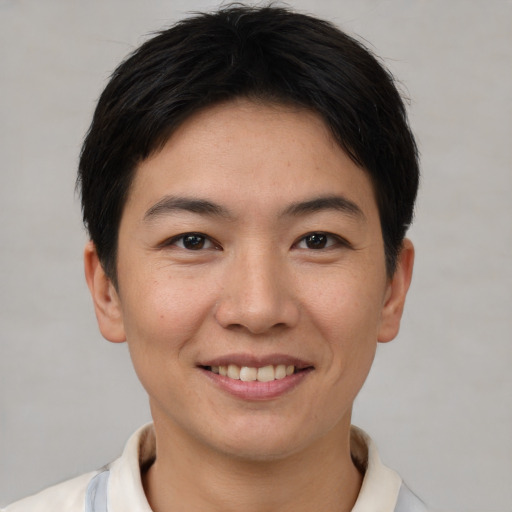 Joyful asian young-adult female with short  brown hair and brown eyes