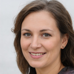 Joyful white adult female with medium  brown hair and grey eyes