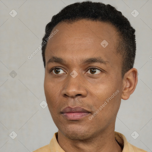 Joyful black young-adult male with short  black hair and brown eyes