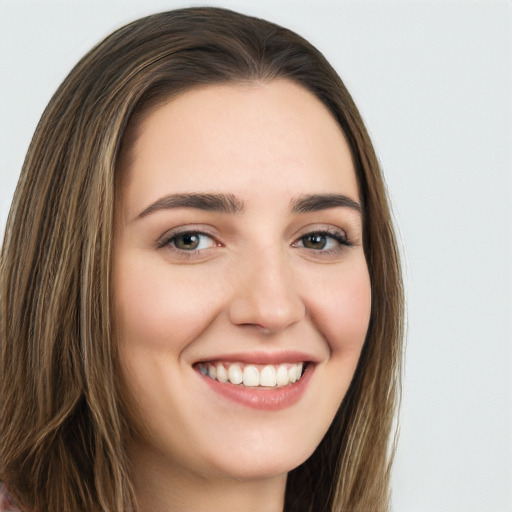 Joyful white young-adult female with long  brown hair and green eyes