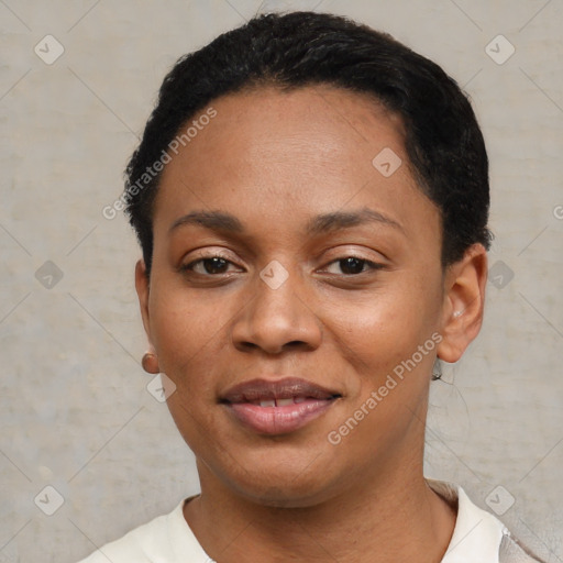 Joyful black young-adult female with short  black hair and brown eyes