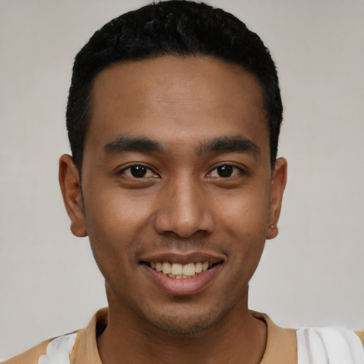 Joyful latino young-adult male with short  black hair and brown eyes