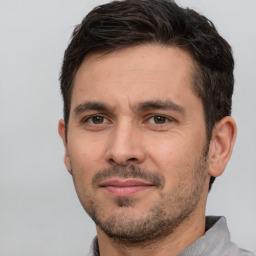 Joyful white adult male with short  brown hair and brown eyes