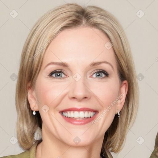 Joyful white adult female with medium  brown hair and blue eyes